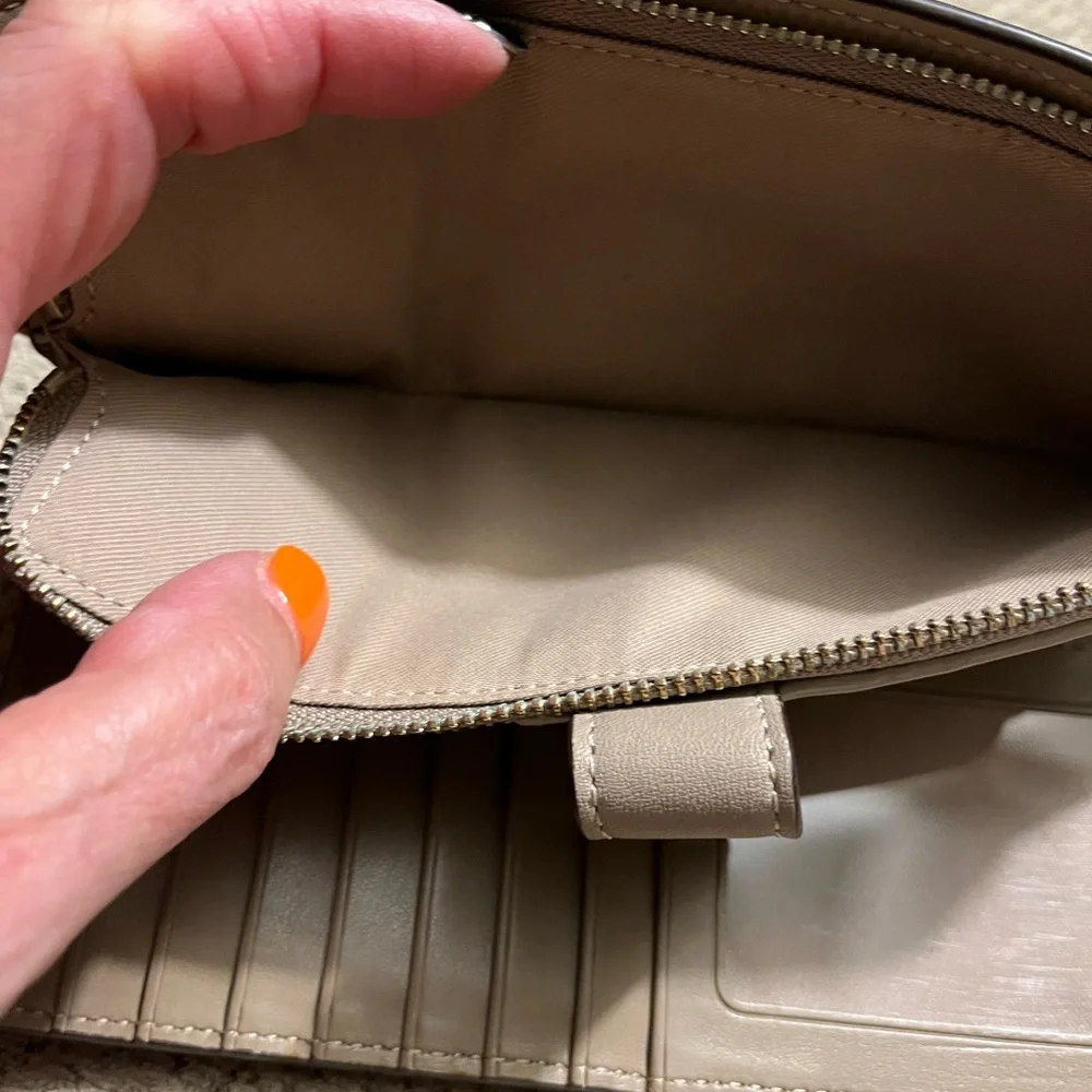 Coach wallet. Has some wear marks and wrinkles on outside of wallet.